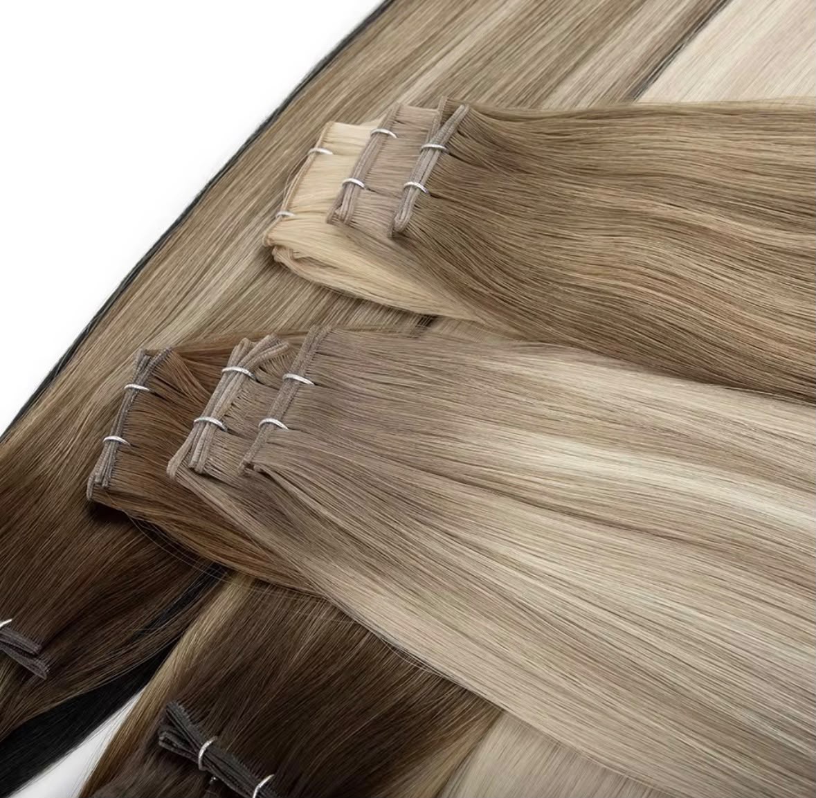 Close-up of glossy straight hair wefts with hand-tied stitching — Premium